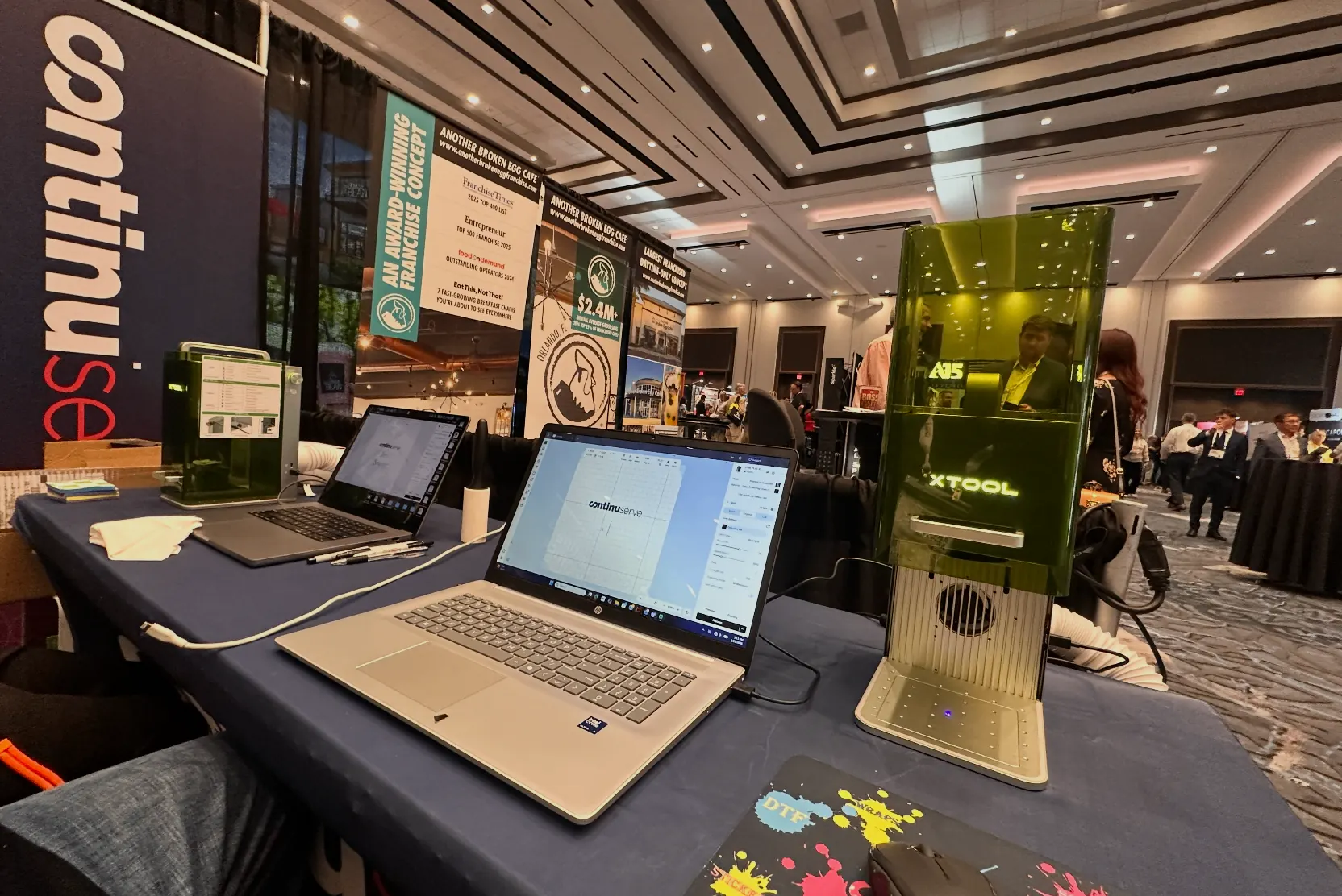 xTool laser engraver set up live on a convention show floor for VIP personalization