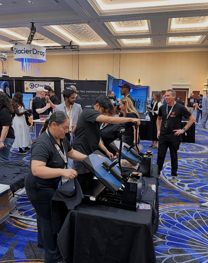Solid Promo Prints crew running a live heat-press activation at a Las Vegas convention