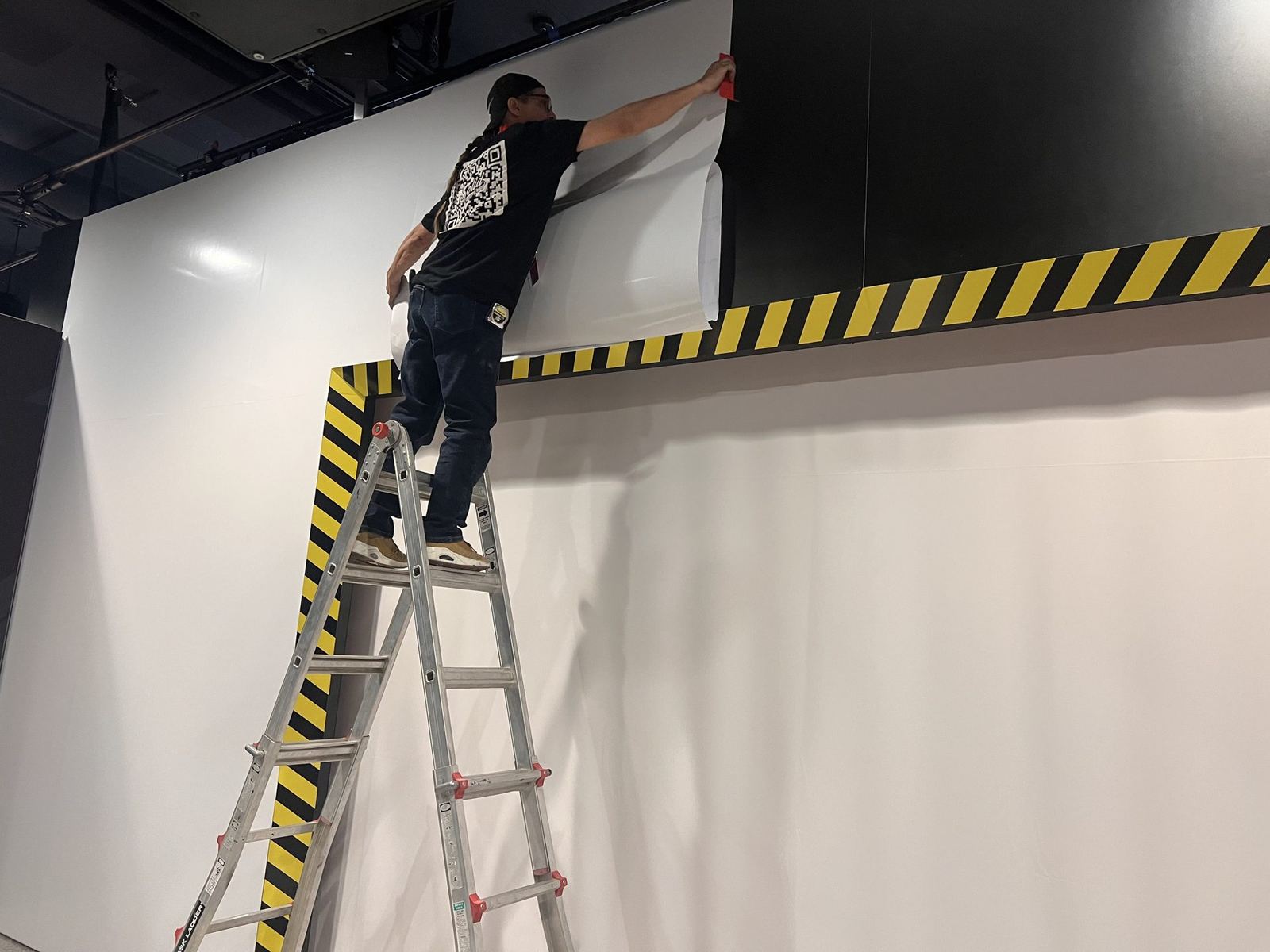 Large-format wall graphic application - show-floor finish work