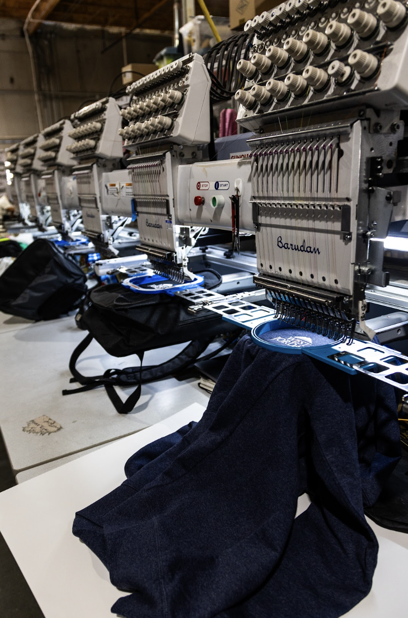 Multi-head Barudan run embroidering branded backpacks