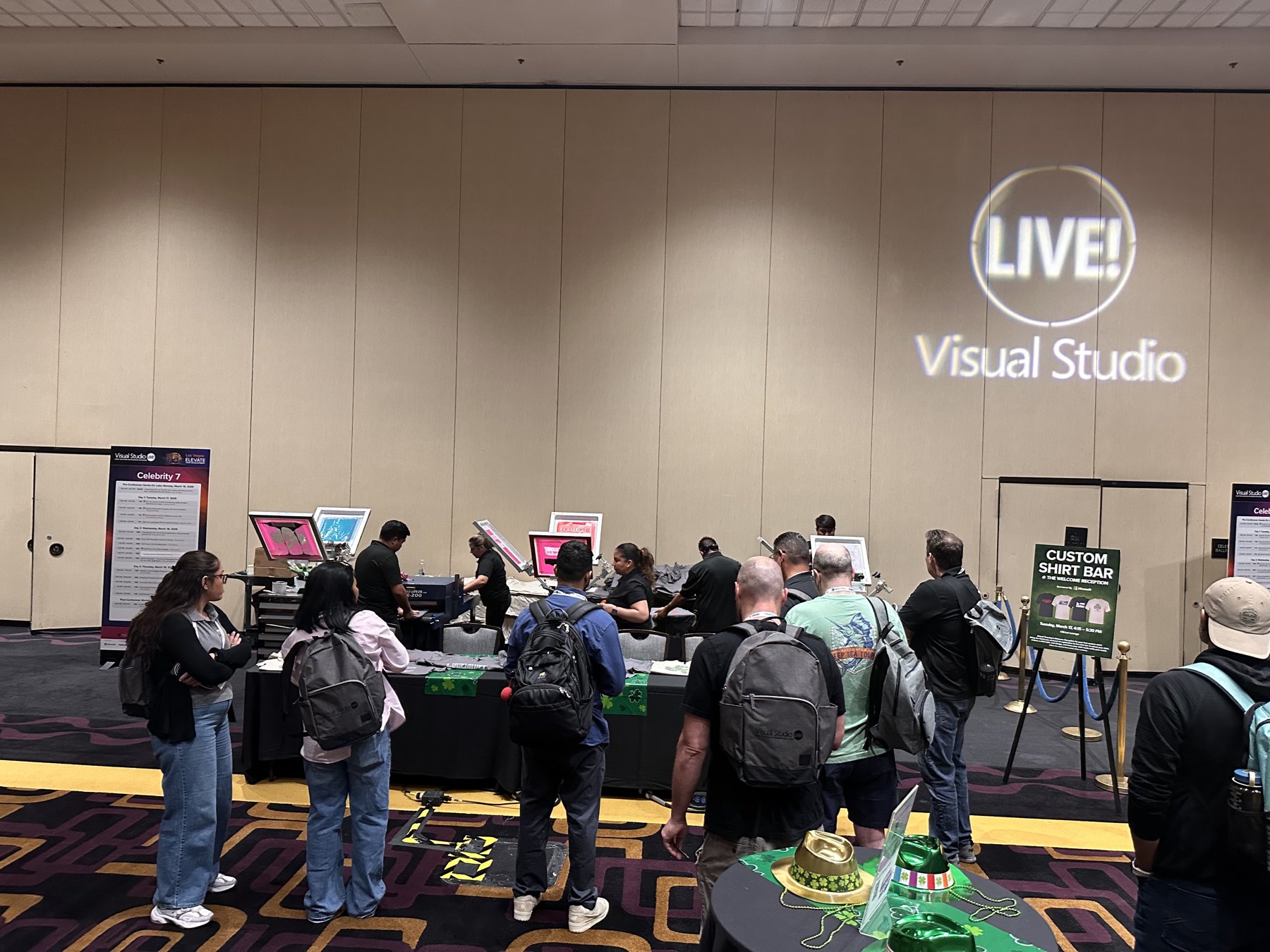 Manual screen-printing press in action at a Vegas convention floor