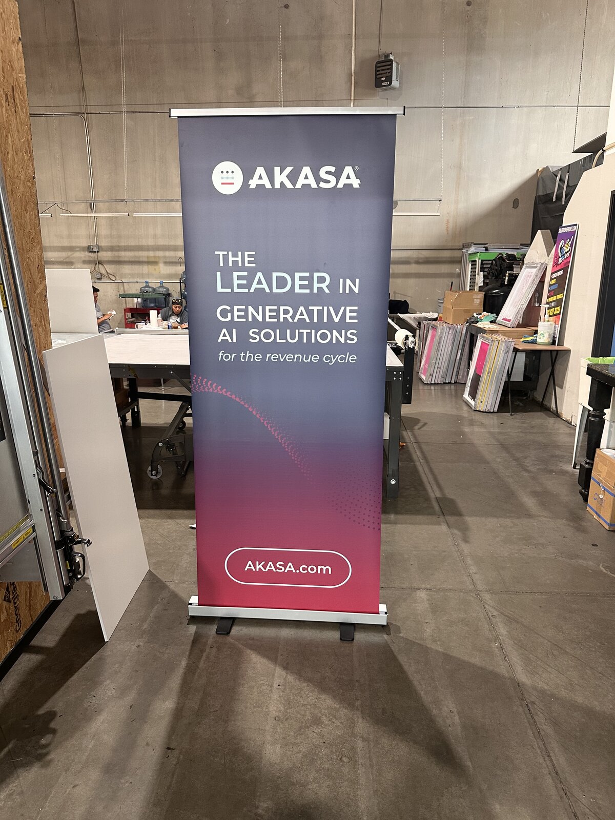 Custom retractable banner stand for AKASA printed and assembled at the Solid Promo Prints shop in Las Vegas