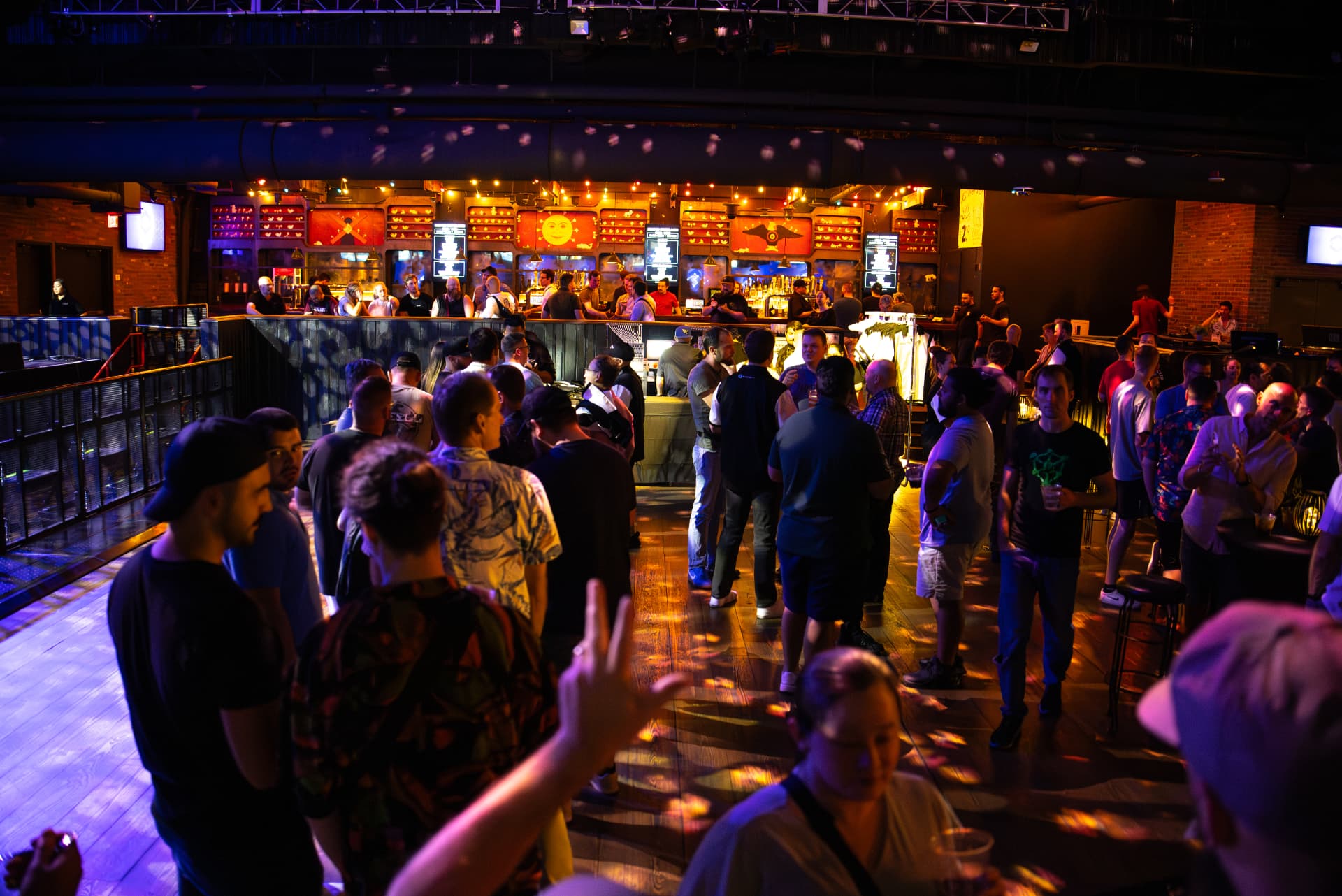 Packed convention event at Brooklyn Bowl Las Vegas with custom-printed venue graphics and a full house