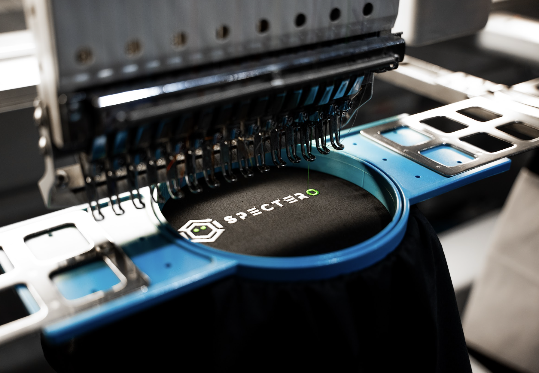 Logo embroidery on performance apparel — magnetic hooping for clean finish