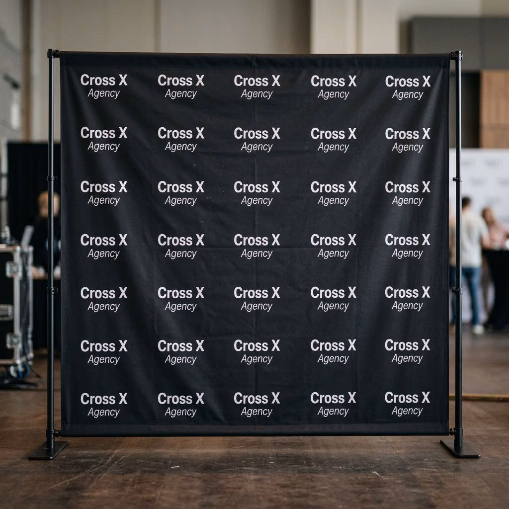 8 ft step-and-repeat backdrop on an adjustable stand, printed with a repeating white Cross X Agency logo pattern on black fabric