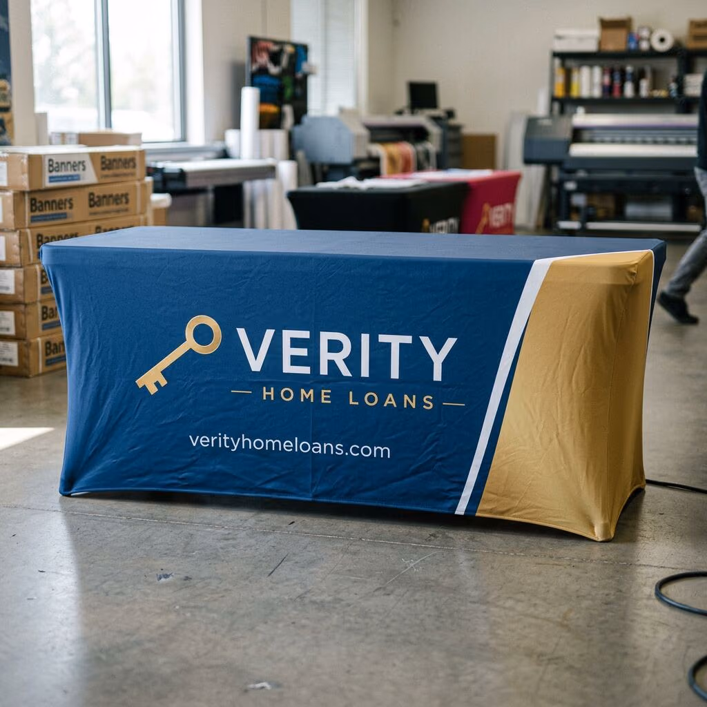 Custom full-color printed stretch table cover with a company logo and gradient brand design on a 6 ft trade show table